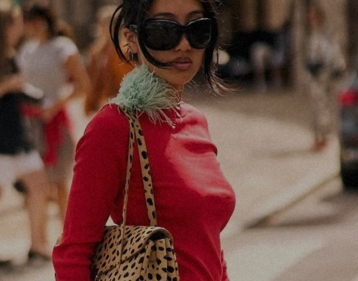 Street-style shot: woman in a red top with a leopard-print bag